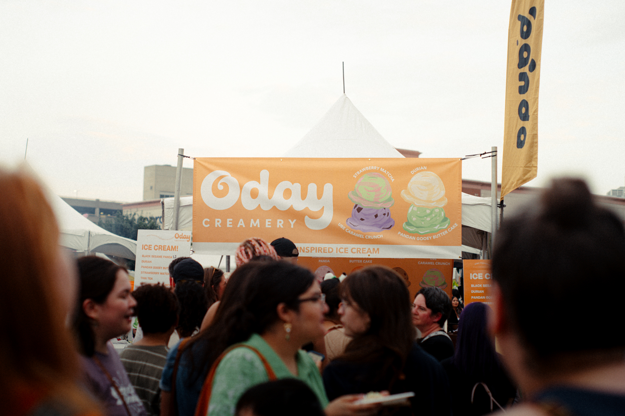 Crowd gathered in front of Oday Creamery booth at an outdoor food festival